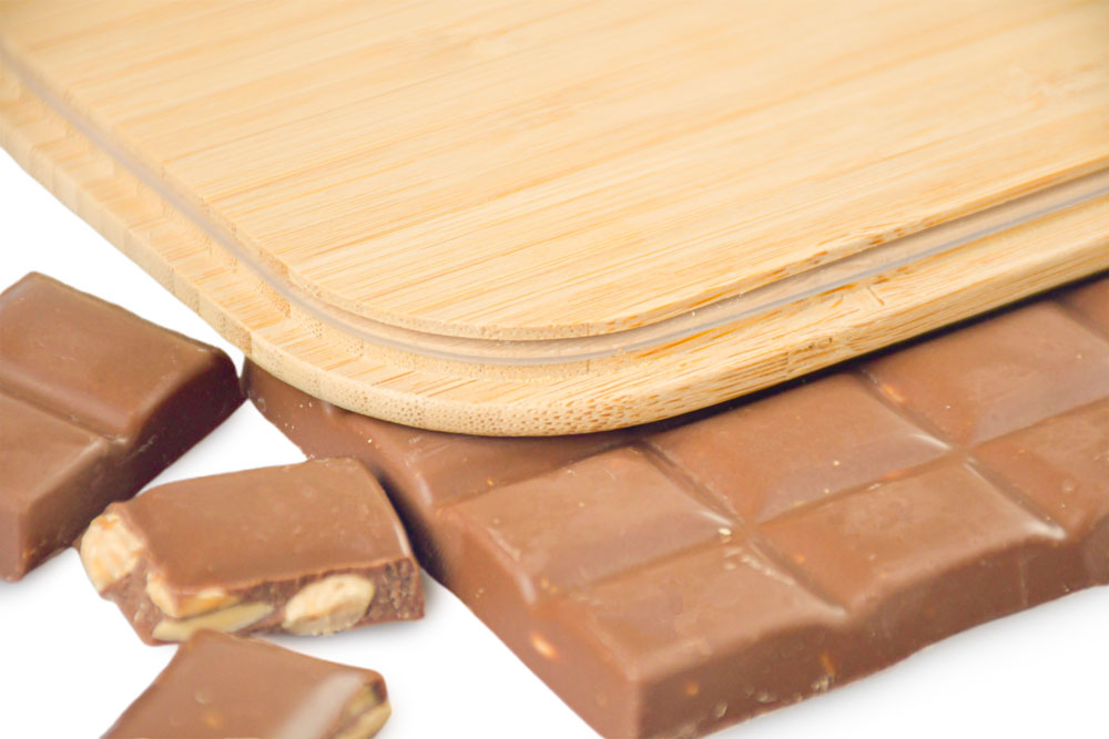 Close-up of bamboo lid on chocolate and tiles – decorative replacement lid for lunch box