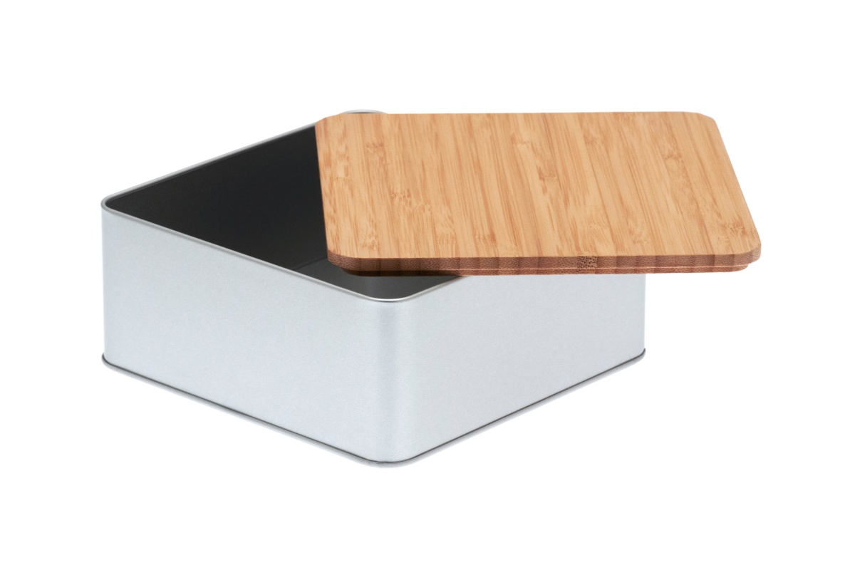 Open square cookie jar made of silver-colored metal with a flat bamboo lid half-open, photographed on a white background.