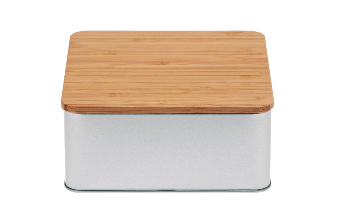 Closed square cookie tin made of silver-colored metal with flat bamboo lid, photographed against a white background.